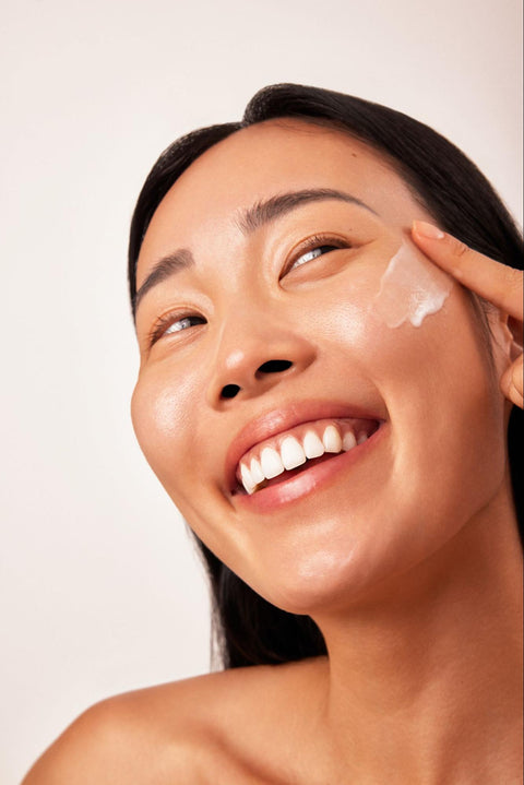 Woman Applying Moisturizer to the Face 