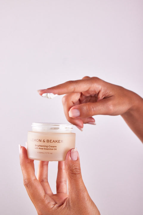 Hands Holding the Lemon & Beaker Brightening Cream 